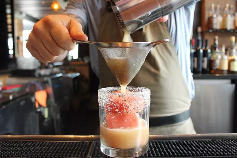 Image: Phil Clark of Blue Hound mixing a vodka cocktail known as Black Pepper Pink Melon.
