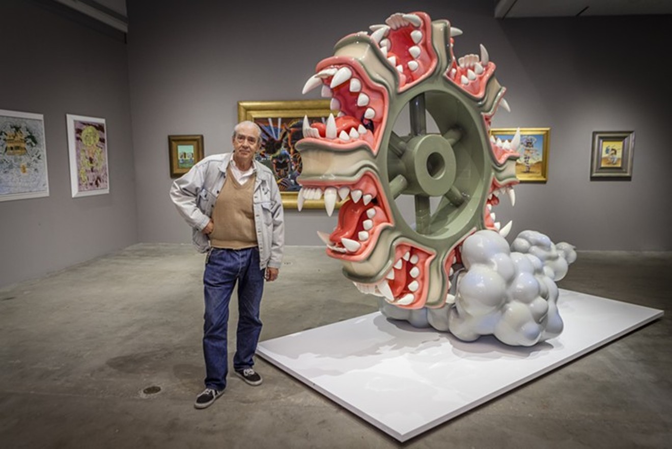 Robert Williams stands with one of his sculptures.