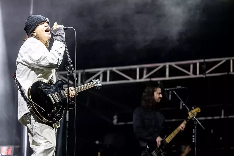 Image: A man performs onstage.