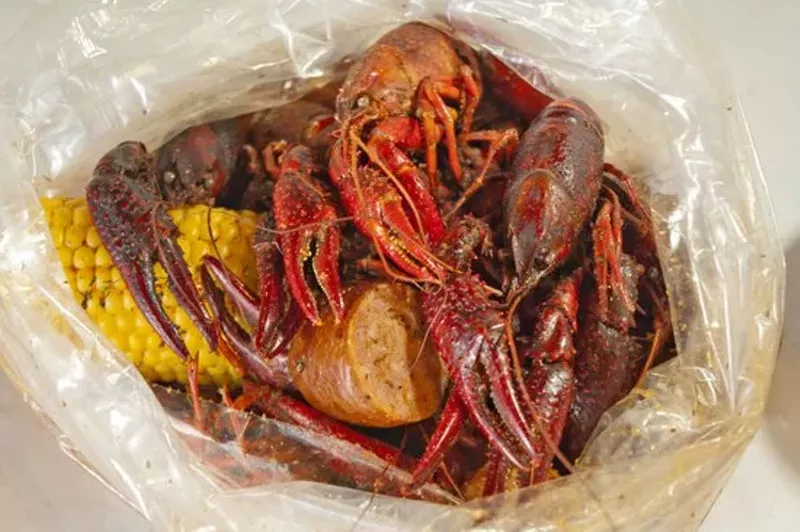 Image: Crawfish swimming in a sea of spices at the Angry Crab Shack.