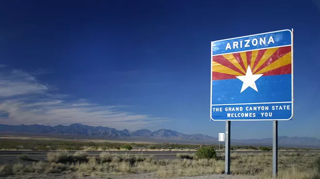 A "Welcome to Arizona" sign on the highway