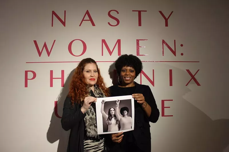 Image: Planned Parenthood supporters D'Lisa Shayn Khademi and Nakia Neves hold their print shot by photographer Mike Patten, who donated his services for the benefit.