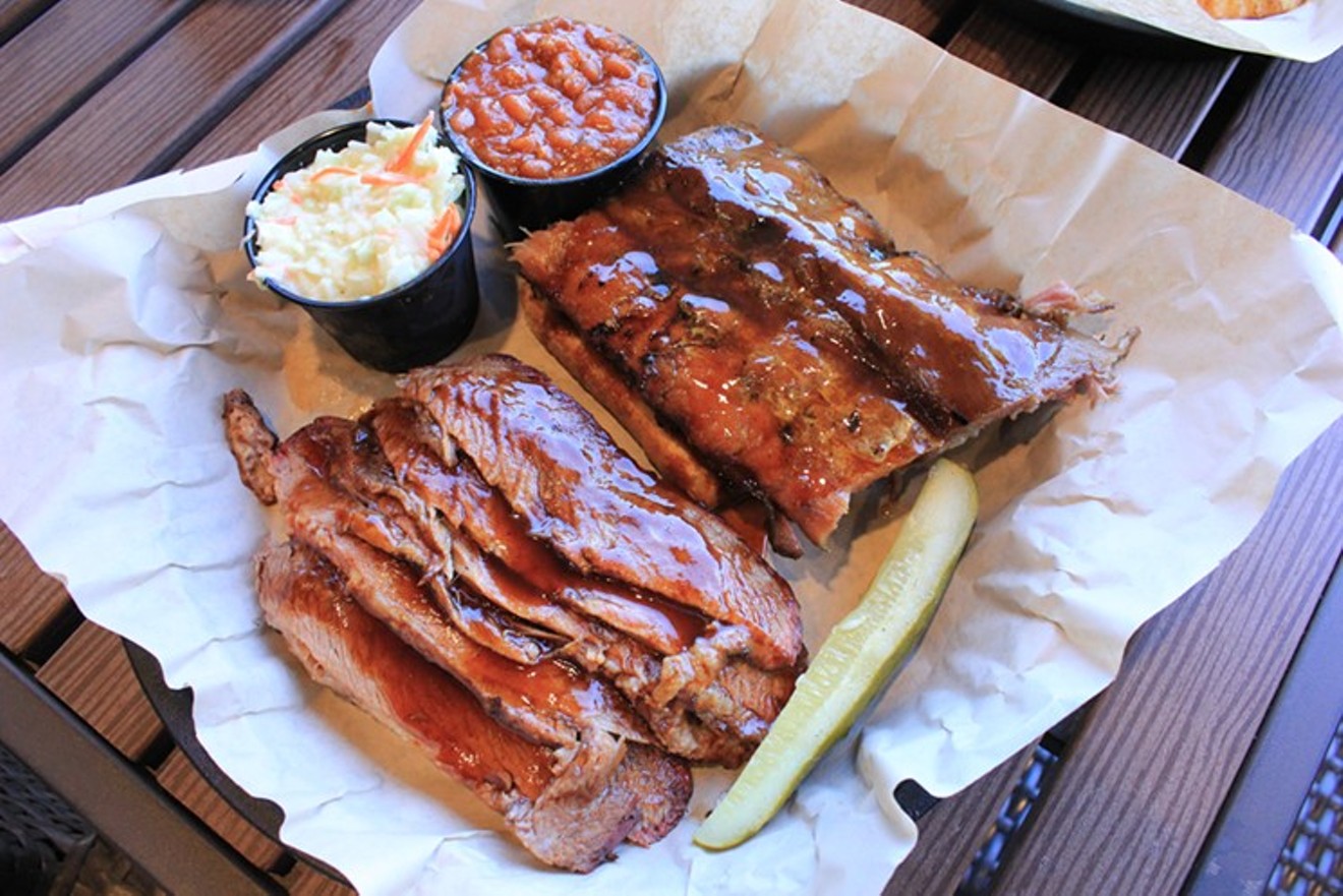 Ribs and brisket smoked over almond wood in West Alley's concrete pit.