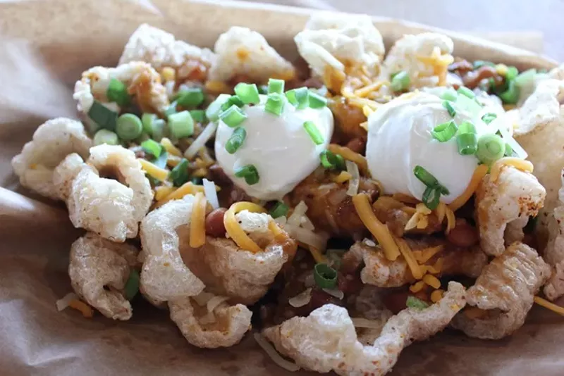 Image: Chicharrones doused with smoked brisket chili at AZ BBQ Company.