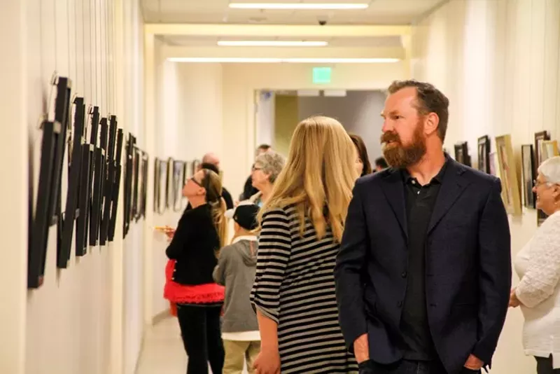 Image: Exploring artwork exhibited at Surprise City Hall.
