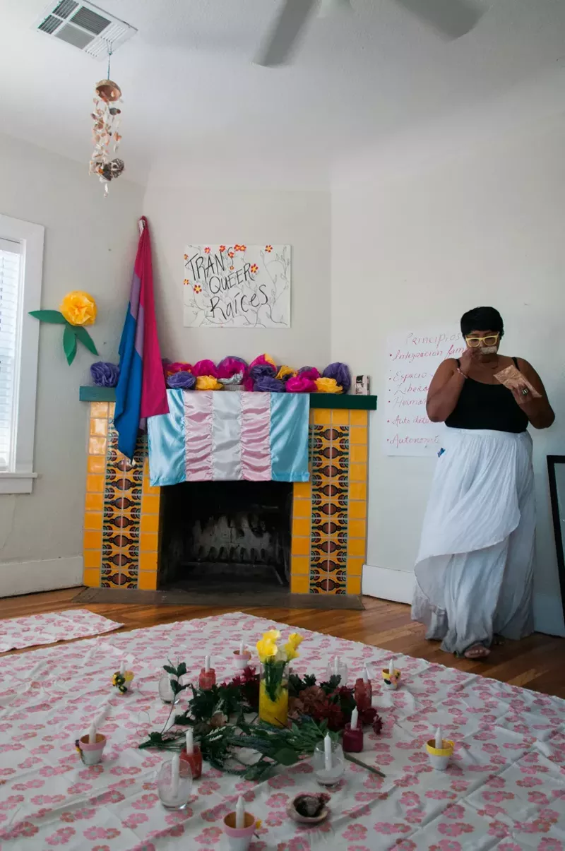 Image: Cynthia Domenzain, 23, from Phoenix, looks over preparations made for Trans Queer Pueblo's healing circle.