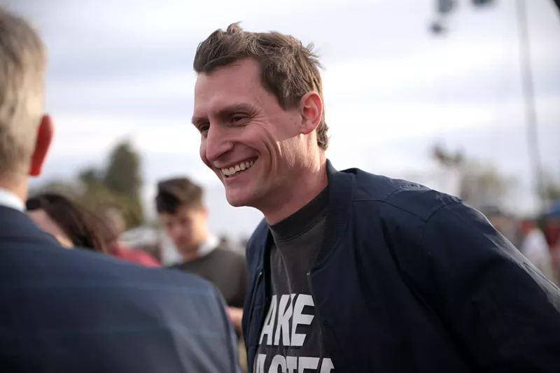 Image: Blake Masters speaks with attendees at a "Save America" rally at Country Thunder Arizona in Florence early this year.