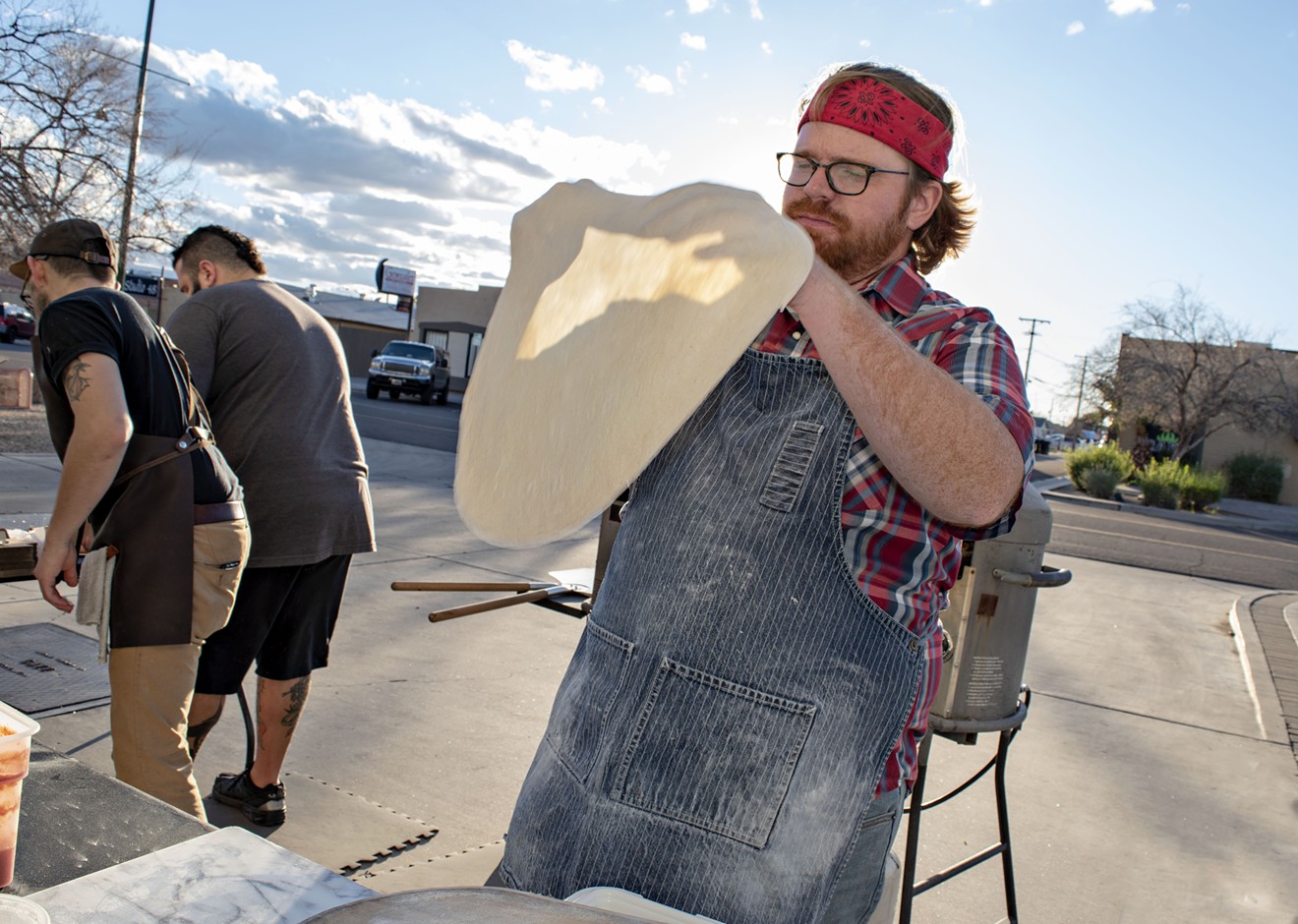 Myke Olsen shapes pizza dough at his pop-up restaurant in Mesa.