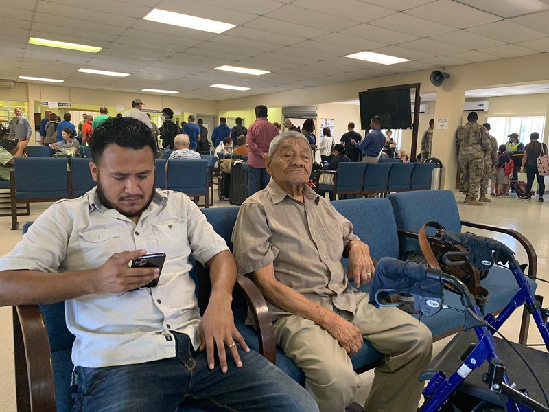 Marta Vasquez's husband and father wait at the Soto Cano Air Base on March 25 to see if they'll be able to board a U.S. military flight back to the United States.