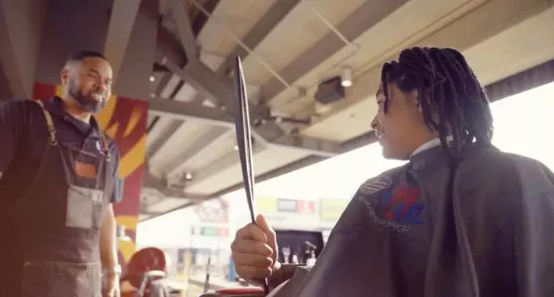 Image: A man giving someone a haircut.
