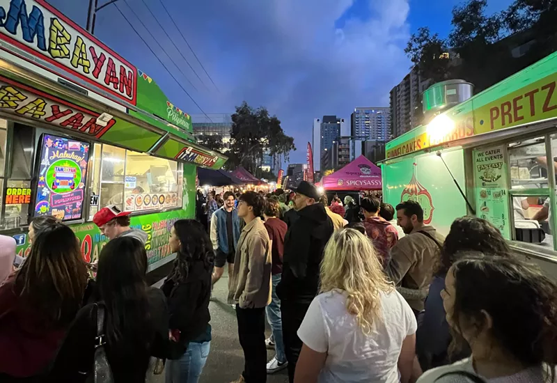 Image: People in line for food trucks.