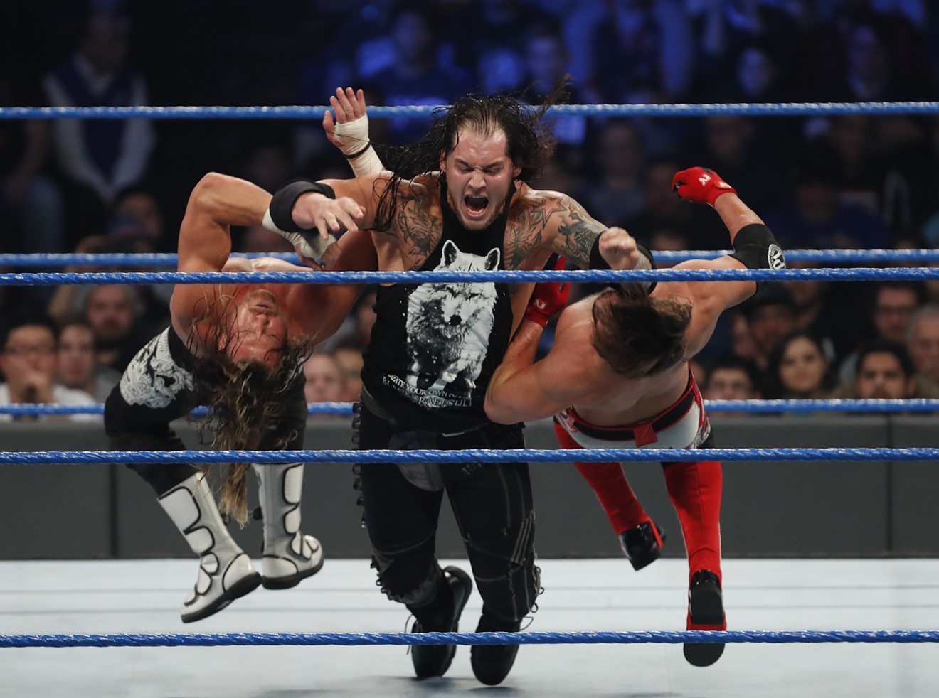 Baron Corbin clotheslines Dolph Ziggler and AJ Styles on an episode of SmackDown Live.