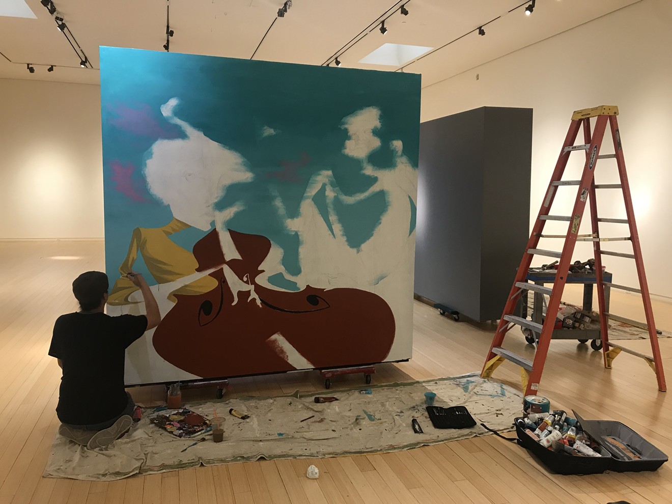 Tato Caraveo paints a mural for the "Jazz It Up!" exhibit at Mesa Contemporary Arts Museum.