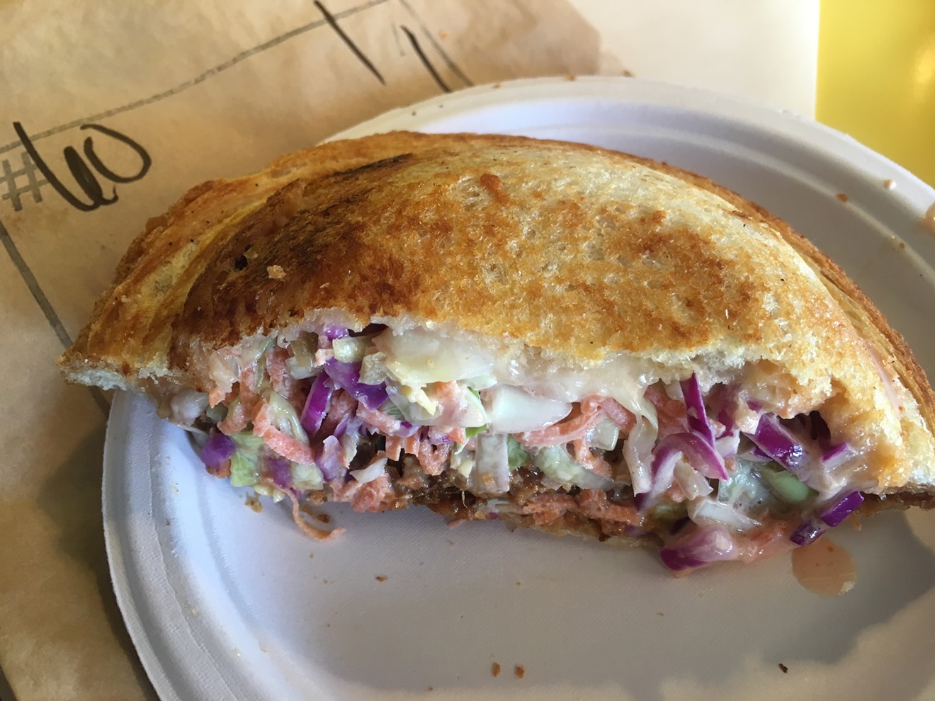 A Zookz stuffed with pulled pork, slaw, and cheese.