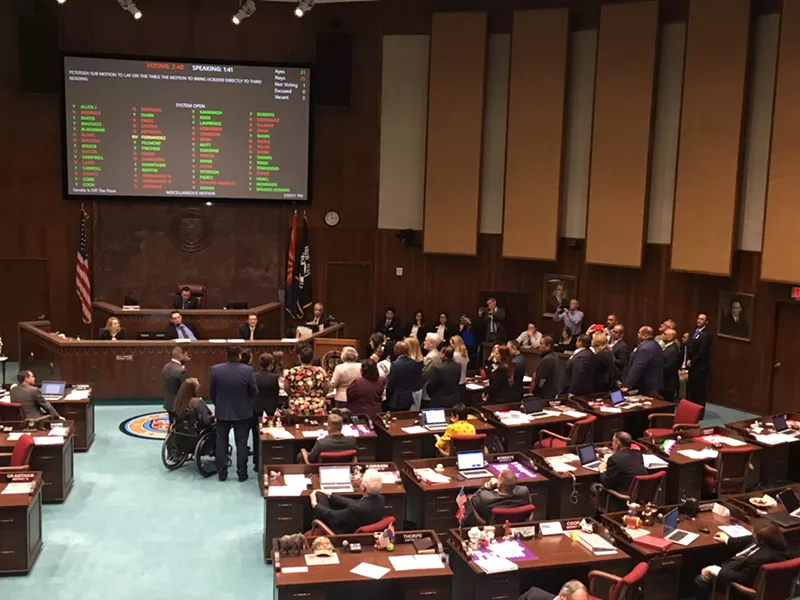 Image: Arizona House Democrats gather around House Democratic Leader Charlene Fernandez as she explains her support for the Equal Rights Amendment.