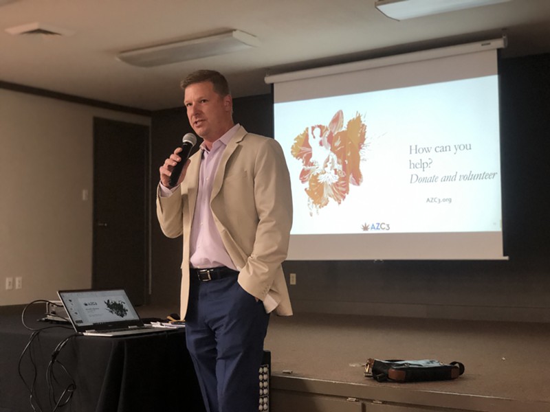 Arizona Cannabis Chamber of Commerce board member Mason Cave explains the group's draft plan for legalization at a public meeting on November 13.