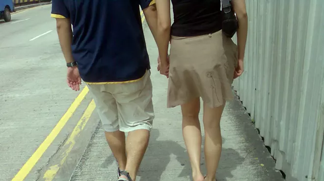 A couple walking down a street.