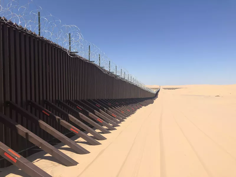 Image: The border wall separating Arizona and Mexico along the Imperial Sand Dunes.