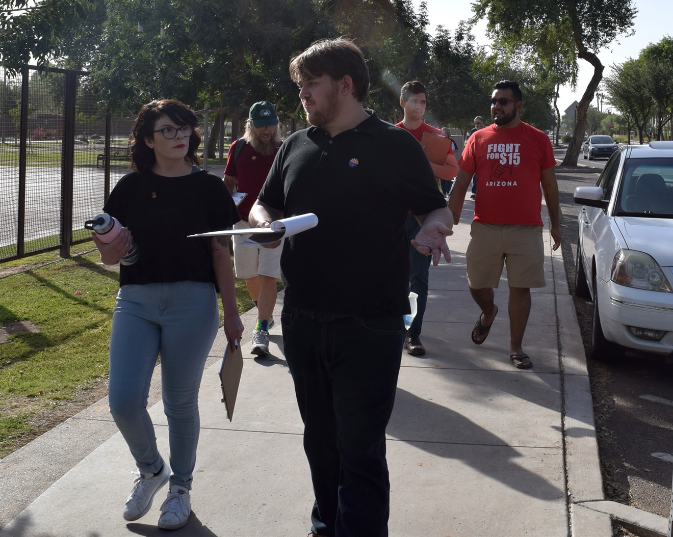 Members of the Phoenix chapter of the Democratic Socialists of America knock on doors in Tempe on October 21. Taylor Cifuentez, left, is the chapter's vice-chair.