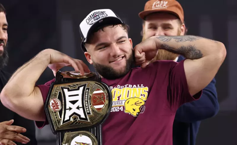 Image: cam skattebo holds a championship belt and flexes his biceps