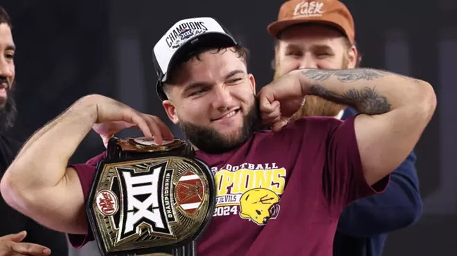 cam skattebo holds a championship belt and flexes his biceps