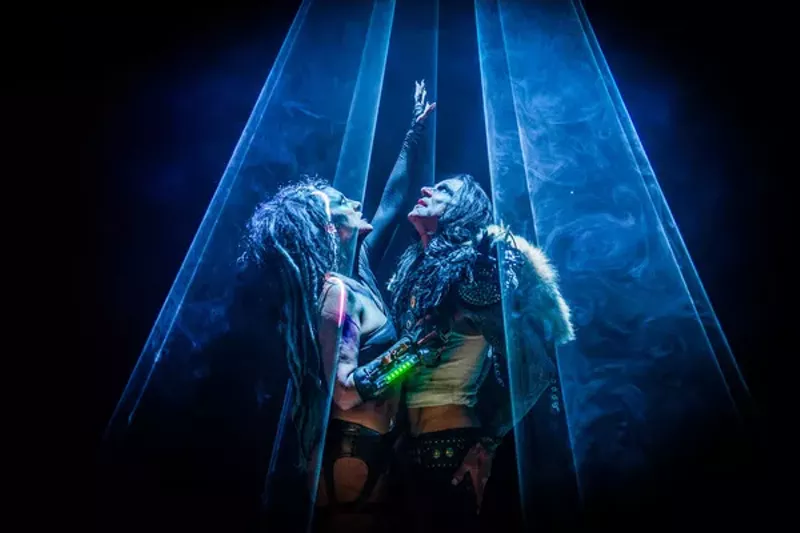 Image: A woman and a man bathed in the spotlight.