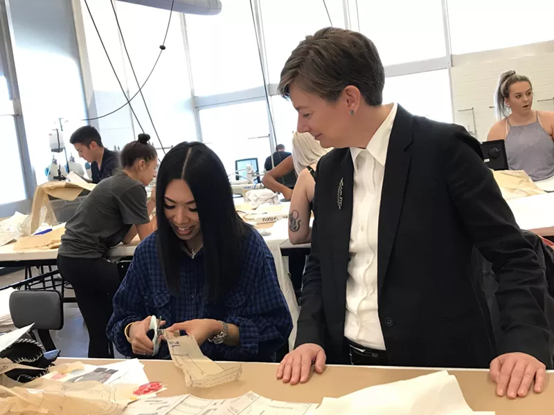 Image: Dennita Sewell talking with a student last September in the ASU fashion studio sewing lab.