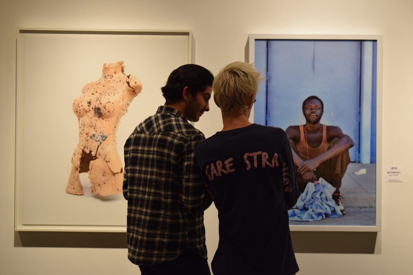 Gallery-goers checking out works by William LeGoullon (left) and Jehu at last year's "Chaos Theory."