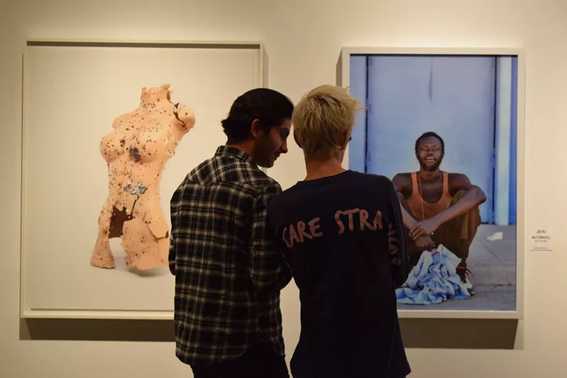 Image: Gallery-goers checking out works by William LeGoullon (left) and Jehu at last year's "Chaos Theory."