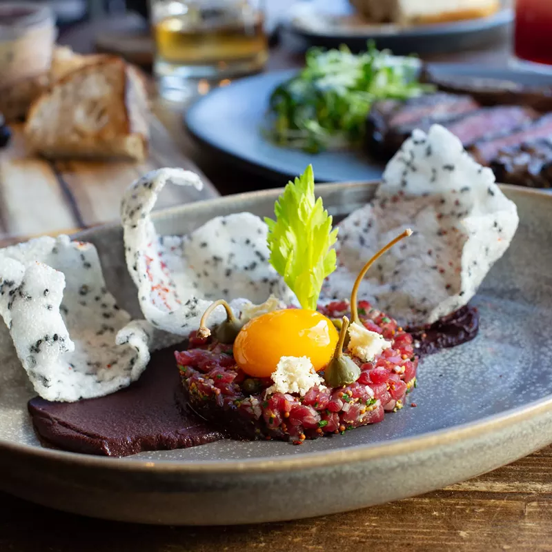 Image: Steak tartar on the new dinner menu at Blue Hound Kitchen & Cocktails.