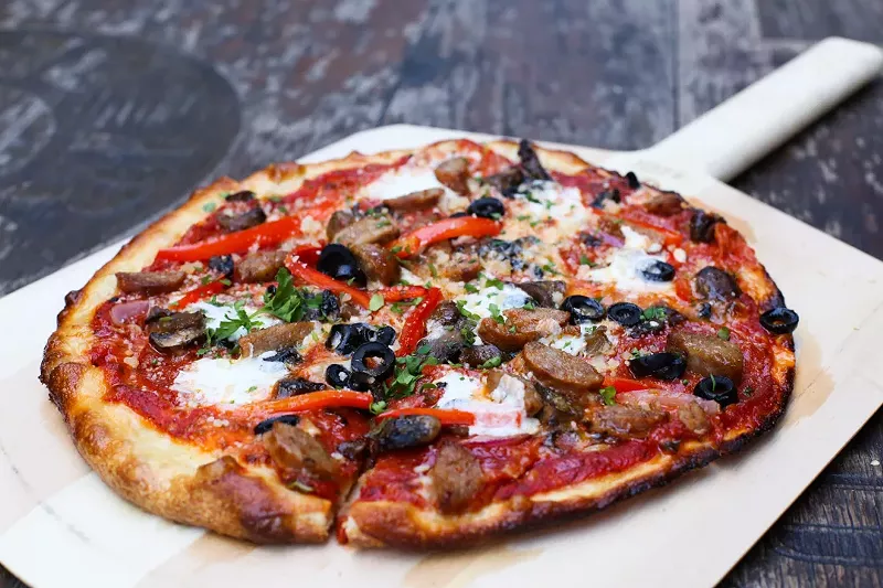 Image: The food menu at Bottled Blonde focuses on pizza, salads, sandwiches and bar staples like wings.