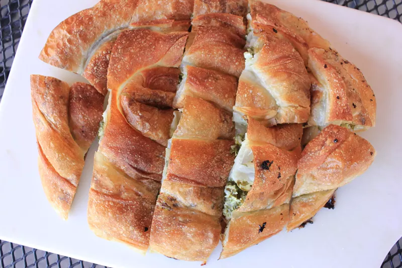 Image: A spinach bourek cut. Jasenko Osmic likes to dip them in the Balkan Bakery's tart yogurt.