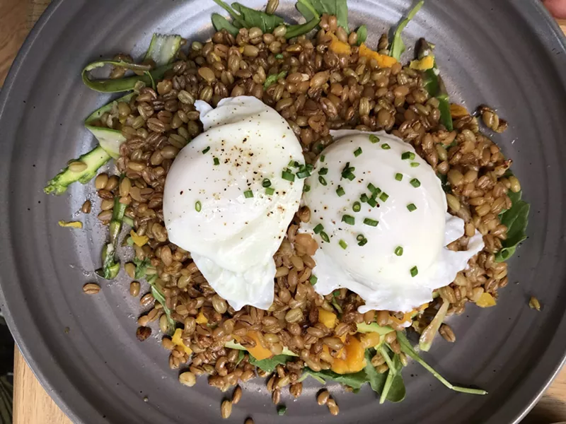 Image: A plate of poached eggs, grains, squash, asparagus, and more.