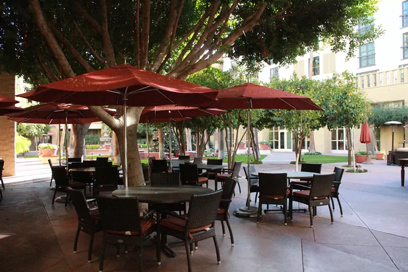 Image: Open patio at Mission Grille in the corner or the citrus tree shaded courtyard at Tempe Mission Palms.
