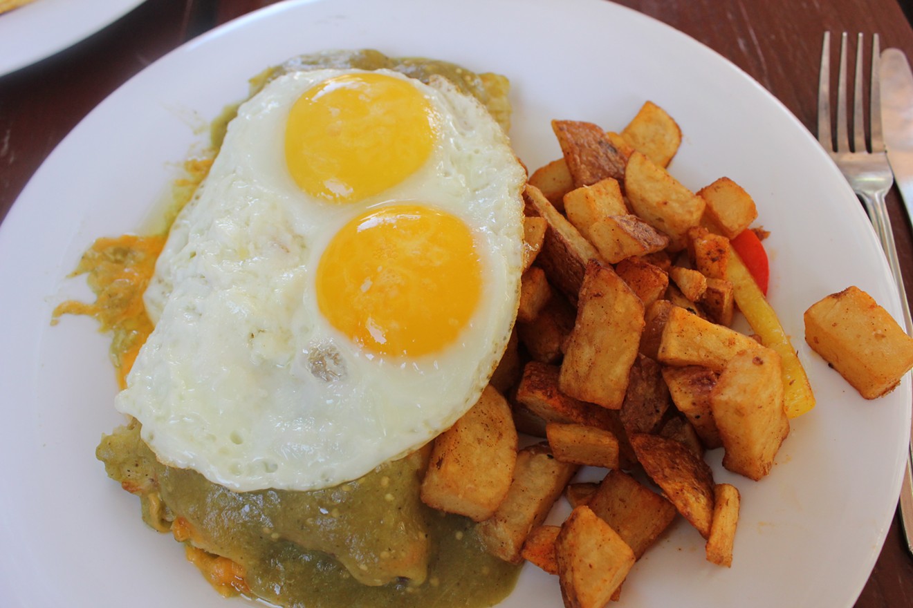 Breakfast enchiladas with sunny-side-up eggs.