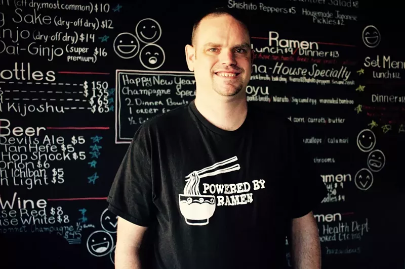 Image: The ramen ronin: Brian Webb stands before Hot Noodles' hand-written menu.
