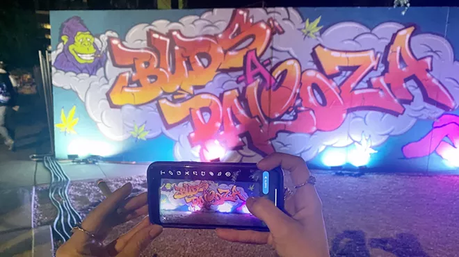 a phone takes a picture of buds-a-palooza graffiti