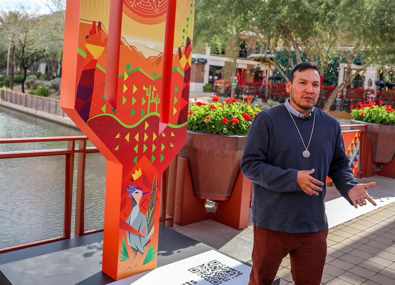 Artist Paul Molina stands with his newly unveiled cactus basketball hoop.