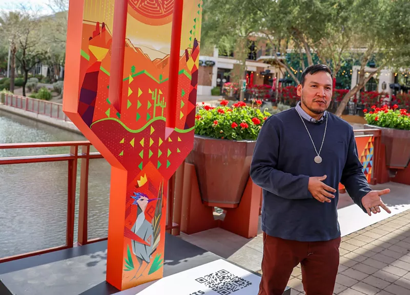 Image: Artist Paul Molina stands with his newly unveiled cactus basketball hoop.