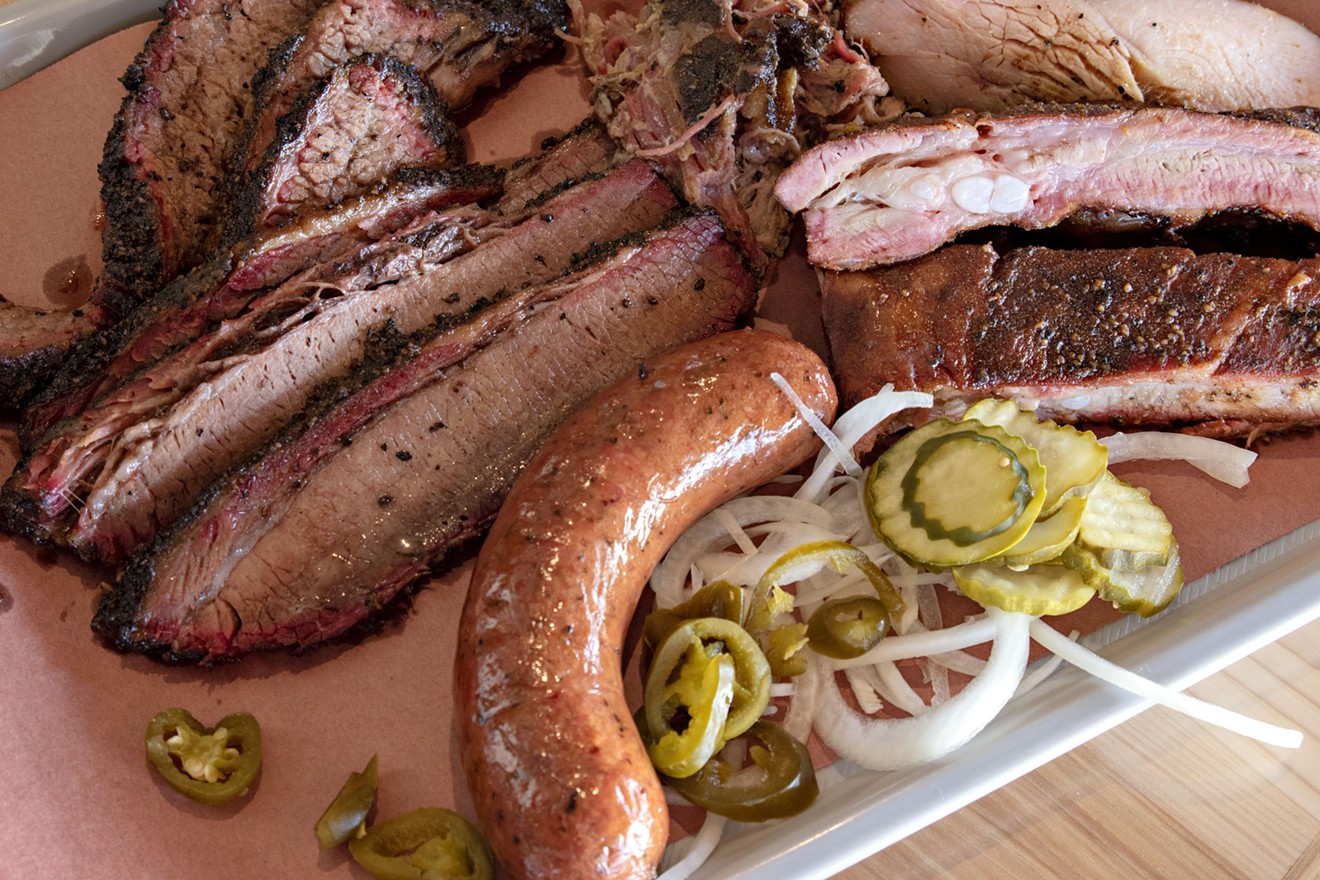 A meat platter is anchored with brisket and lightened with pickles and onions.