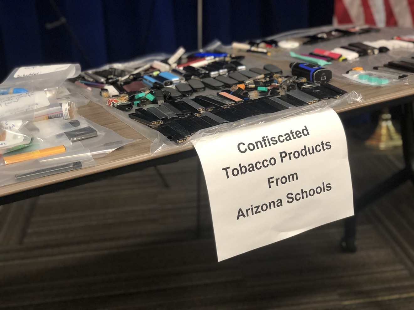 Plastic bags full of vaping products confiscated from Arizona high schools sit on display at a press conference Tuesday.