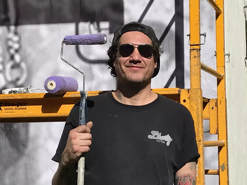 Image: Cheyenne Randall during the installation for his murals at the Heard Museum.