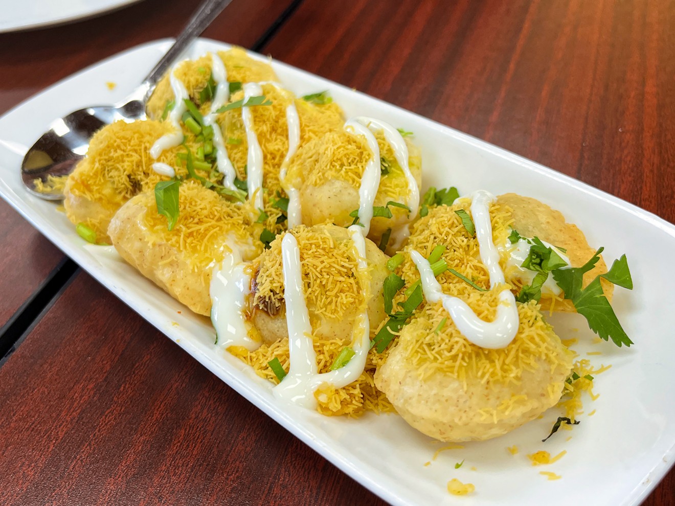 Dahi puri are crisped wheat shells filled with vegetables and a wild combinations of chutneys, yogurts, herbs and sev — tiny chickpea noodles.