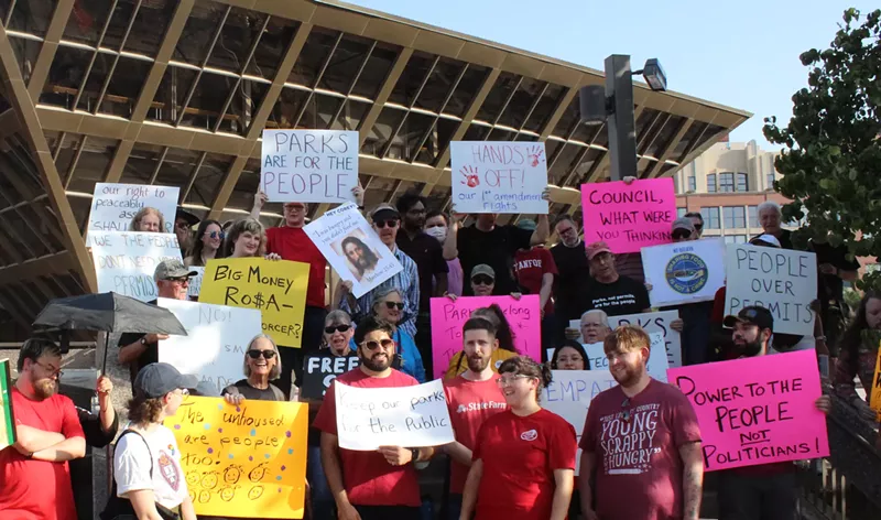 Image: protesters hold signs in front of tempe city hall