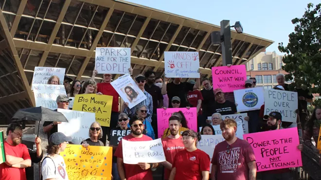 protesters hold signs in front of tempe city hall