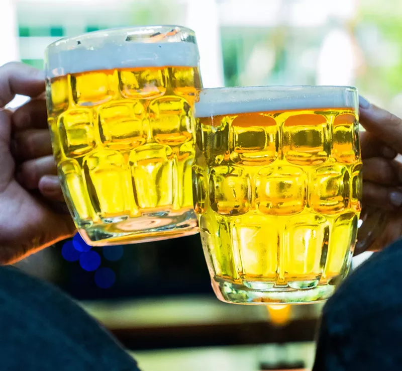 Image: Clinking two beer mugs.