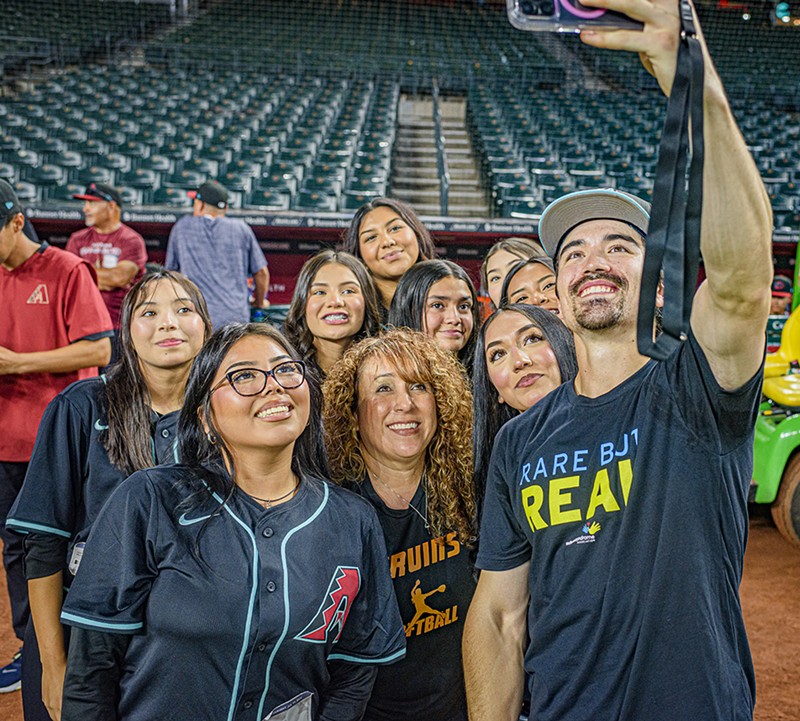 Diamondbacks star Corbin Carroll takes a selfie with Arizona high school softball players after surprising them with custom jerseys.