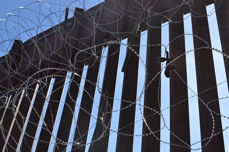 Image: A tall border fence has long separated Nogales, Arizona, from Nogales, Mexico.