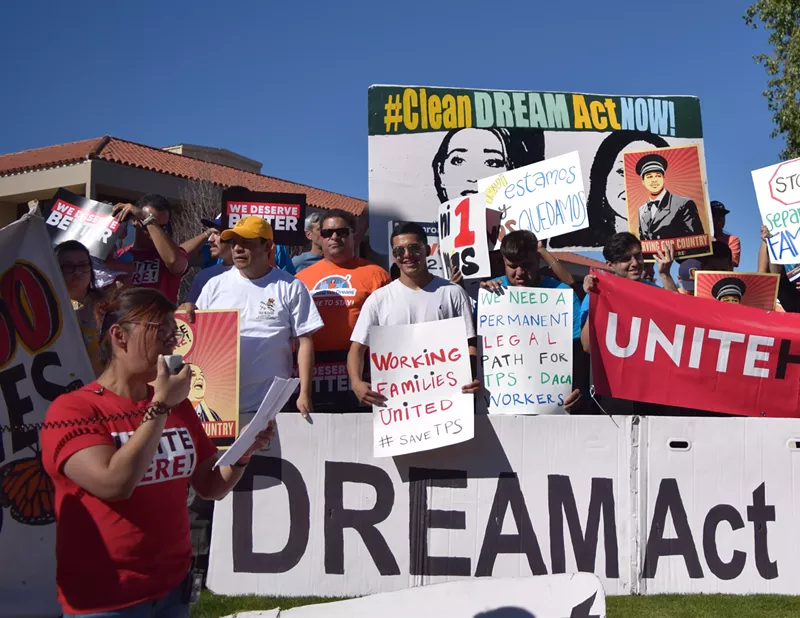 Image: Betty Guardado, vice president of service industry union Unite Here Local 11, addresses the media at a demonstration outside Senator Jeff Flake's office in Phoenix.