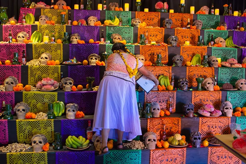 Image: Rufina Ruíz López works on the Desert Botanical Garden's Día de Muertos altar.